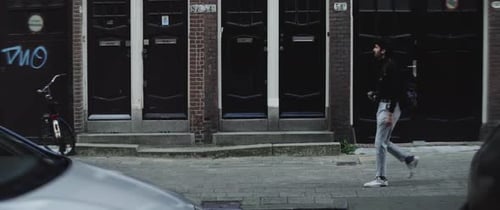 Young caucasian man walking and taking photos in the city