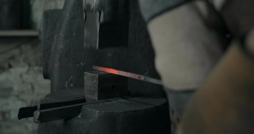 Blacksmith Uses a Hydraulic Hammer to Forge Hot Metal in His Workshop Automatic Hammer is Shaping