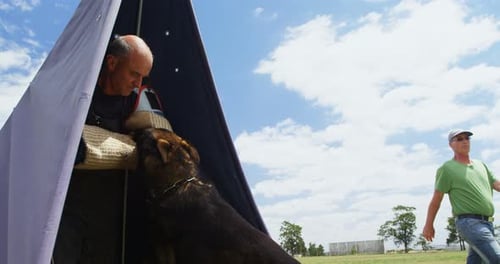 Trainer training a shepherd dog in the field 4k