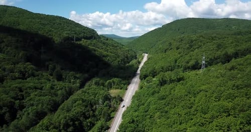 Aerial View of a Rural Highway Between Mountains