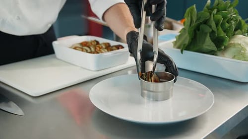 The chef serves ratatouille on a plate. Exquisite dish in an expensive restaurant.