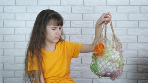 Girl with Plastic Garbage in a Bag