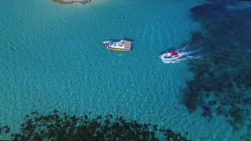 A motor boat cruising in blue lagoon malta