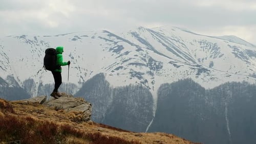 Hiker Exploring Mountain Landscape in Winter