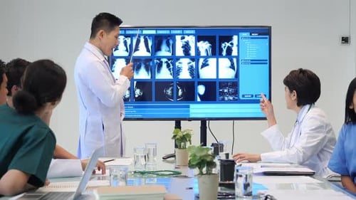 Medical Professionals Analyzing X-rays in Hospital Meeting