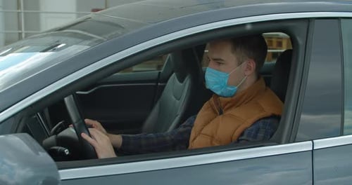 Man in Car Wearing Protective Face Mask