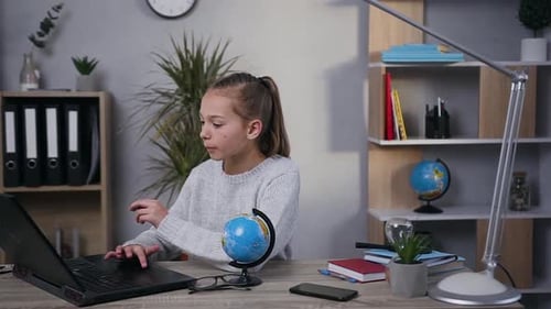 Child working on a laptop at home
