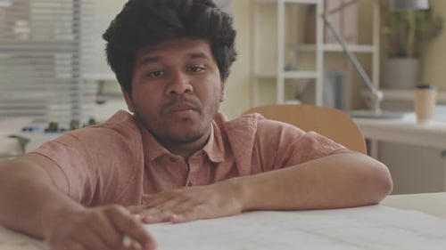 Biracial Architect Drawing Building Plan in Workshop