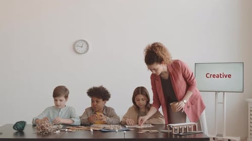Woman Teaching Children on Workshop