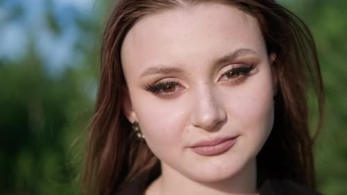 Young Woman Portrait with Brown Hair and Freckles