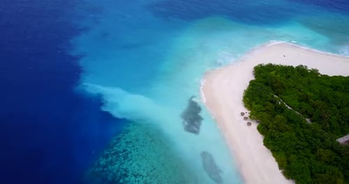 Beautiful birds eye travel shot of a white sandy paradise beach and aqua blue water background in vi