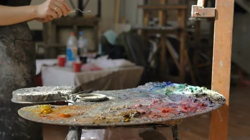 Young Adult Artist Painting in Studio