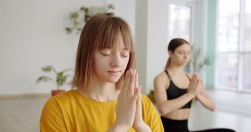 Young Women Meditating Calmly Indoors