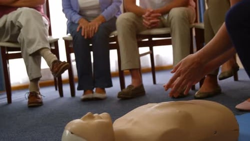 Doctor performing resuscitation training on a dummy