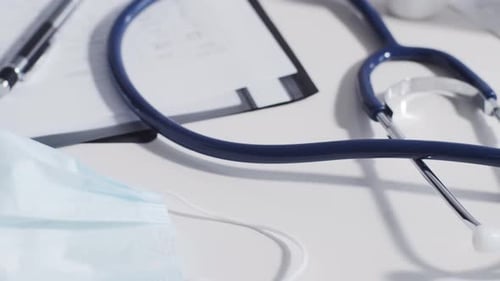 Close-up of different stuff and equipment on doctor's table in medical office in hospital.