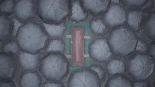 Grave Site Funeral Service with Coffin and Umbrellas in Rain