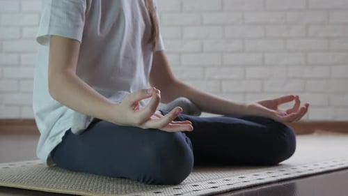 Young Adult Practicing Yoga and Meditation at Home
