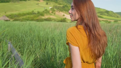 Girl walking in a reed field