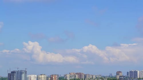 Light Clouds in the Blue Sky Above the City