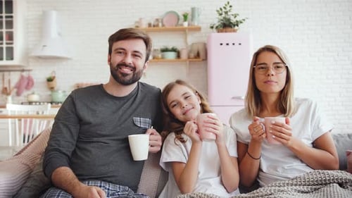 Family Relaxing Together on Couch at Home