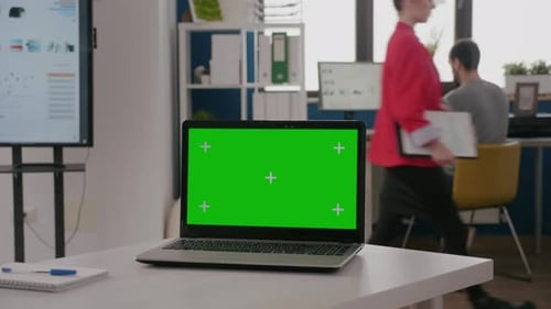 Close Up of Laptop with Green Screen on Empty Office Desk