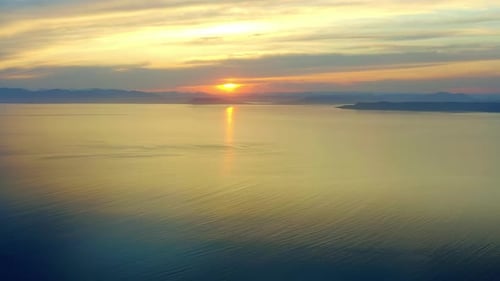Drone Flying Over the Sea During the Golden Hour of Sunset