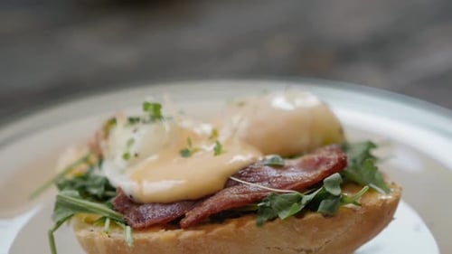 Eggs Benedict with Bread and Tomato on a Plate with Becon Morning Sandwich