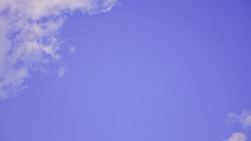 White Clouds Drifting Across Blue Sky