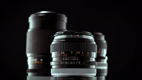 Vintage 50mm Camera Lens Spinning On Black Studio Background