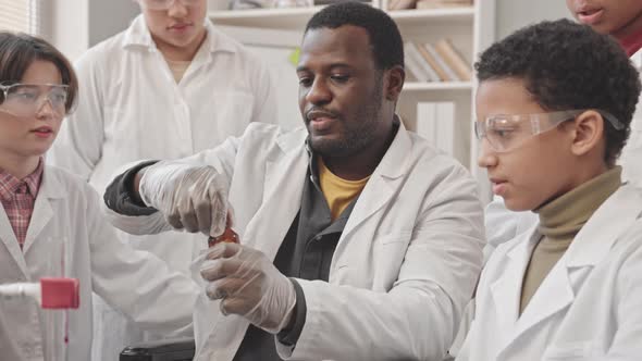 Science Teacher Showing Lab Experiment to Students, Education Stock ...