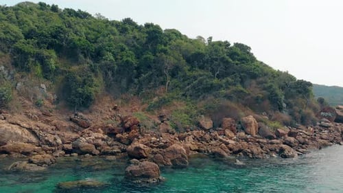 Flycam zieht zu Island Forest Stones und ozeanblauem Wasser