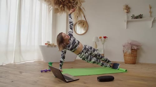 Woman Exercising at Home Doing Side Planks