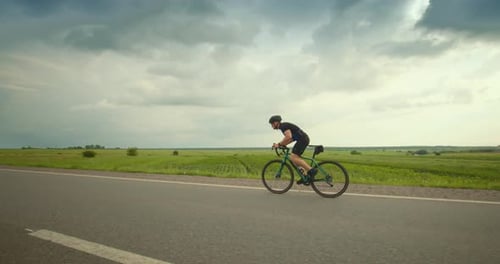 A Cyclist is Riding on the Road