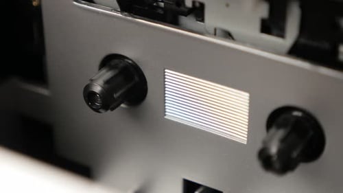 Shallow DOF compact cassette recording device 3840X2160 UltraHD tilting footage - Close-up of supply