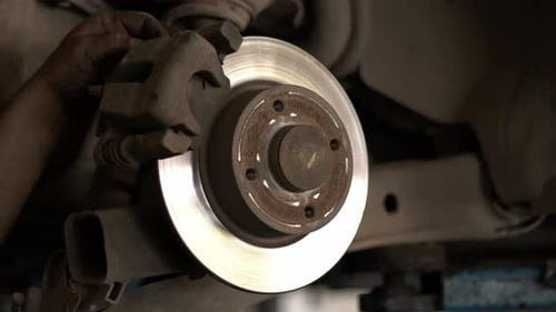 Replacing Old Brake Discs Of A Car In A Repair Shop 1
