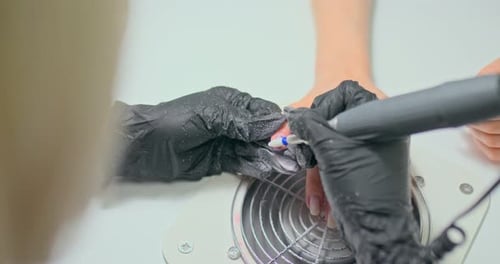 Manicurist Works As a Manicure Machine and in Gloves, Removes Gel Polish From the Client's Nails