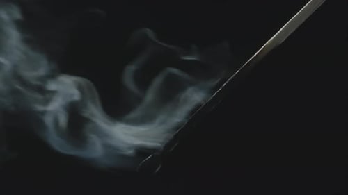 Burning Match with Wisp of Smoke on Black