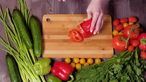 Top View Hands of a Woman Cutting Vegetables.