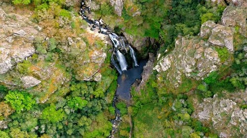 Aerial Birds Eye View Of Fervenza do Toxa Waterfalls Cascading Down Rockface. Pedestal Down