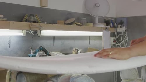 Male surfboard maker in his workshop