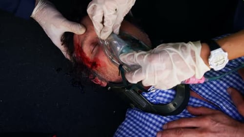 Emergency medical technician posing an oxygen mask