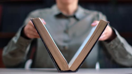 Unrecognizable Academic Woman Open Vintage Paper Book Antique Text Publication at Library Desk