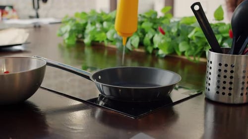 Slow Motion of Person's Hand in Glove Putting Chopped Vegetables in Frying Pan