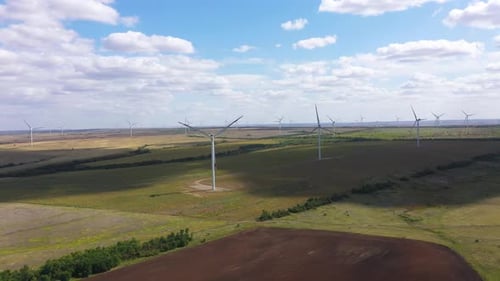 Aerial View Over the Farm Landscape and Wind Turbines Generating Clean Renewable Energy