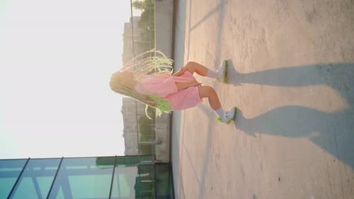 Stylish Young Woman Breakdancing on Urban Rooftop