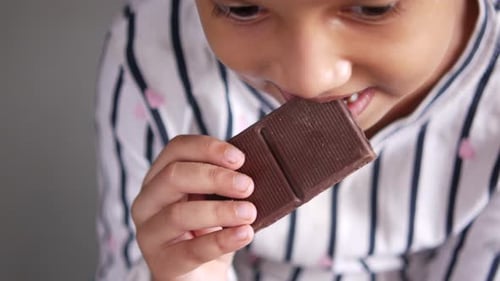 Child Girl Eating Chocolate Candy