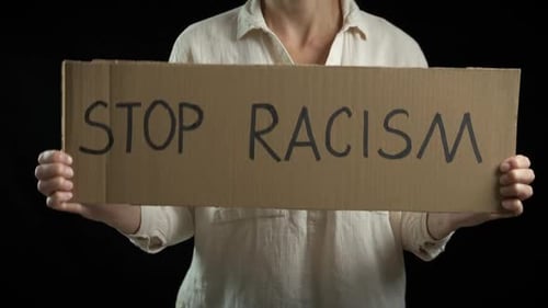 Person Holding a Sign Saying Stop Racism
