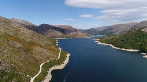 Modern Dam Reservoir on Blue Lake Waters Generate Alternative Energy in Highland Wild Area