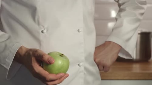 Chief Throws Up A Green Apple In A Hand