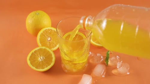 Orange Juice Pour with Fresh Fruit and Ice